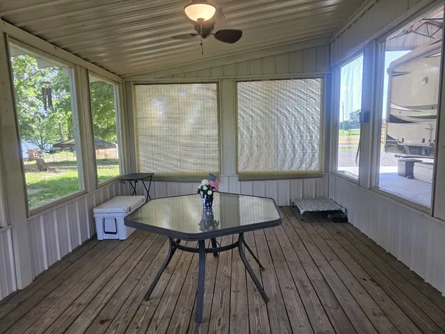 a dining room with wooden floor and a table