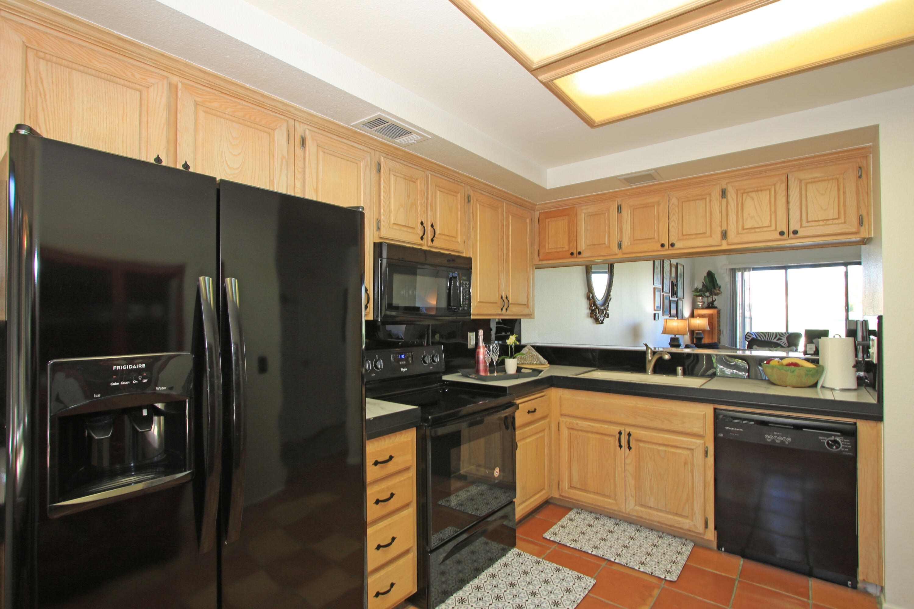 72 Old Ranch Road Palm Desert, CA 92211 - Photo 12 of 35 a kitchen with a sink a refrigerator and cabinets