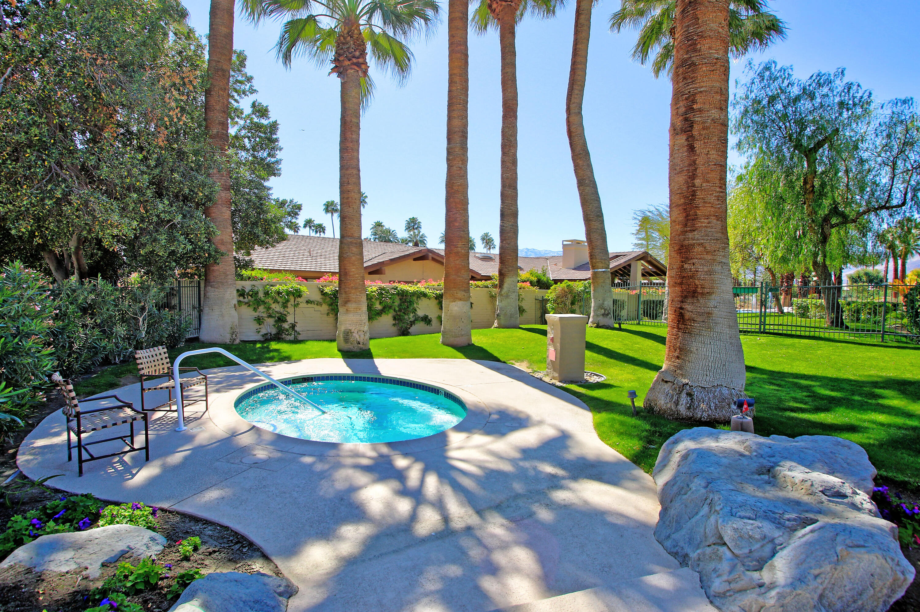 72 Old Ranch Road Palm Desert, CA 92211 - Photo 17 of 35 a view of a swimming pool with a garden and patio
