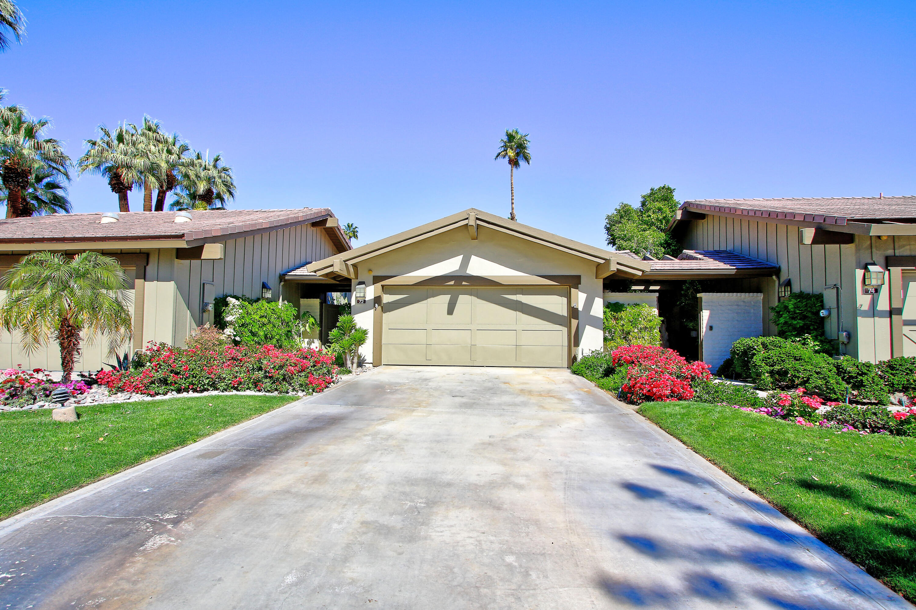 72 Old Ranch Road Palm Desert, CA 92211 - Photo 2 of 35 a front view of a house with a yard and potted plants