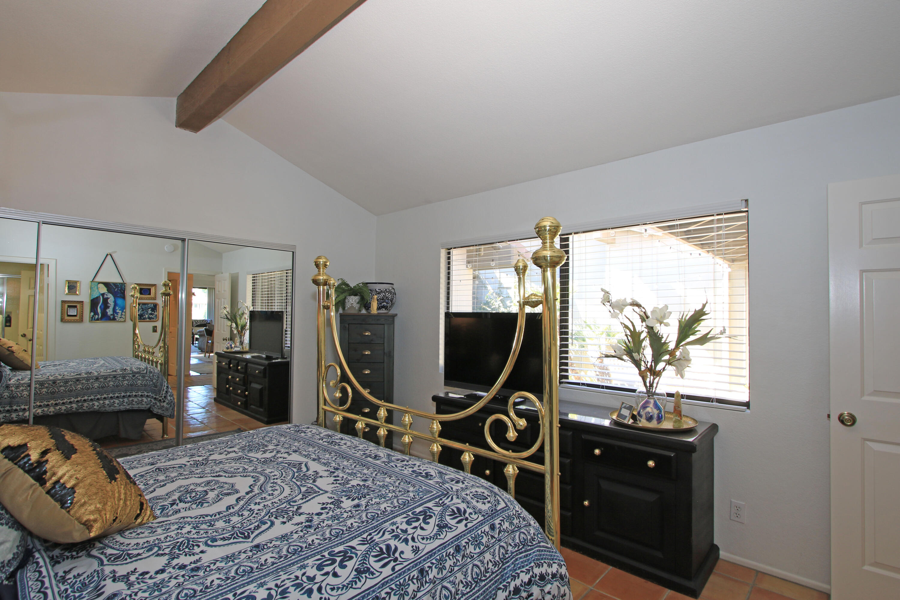 72 Old Ranch Road Palm Desert, CA 92211 - Photo 23 of 35 a bedroom with a bed and a flat tv screen on a dresser