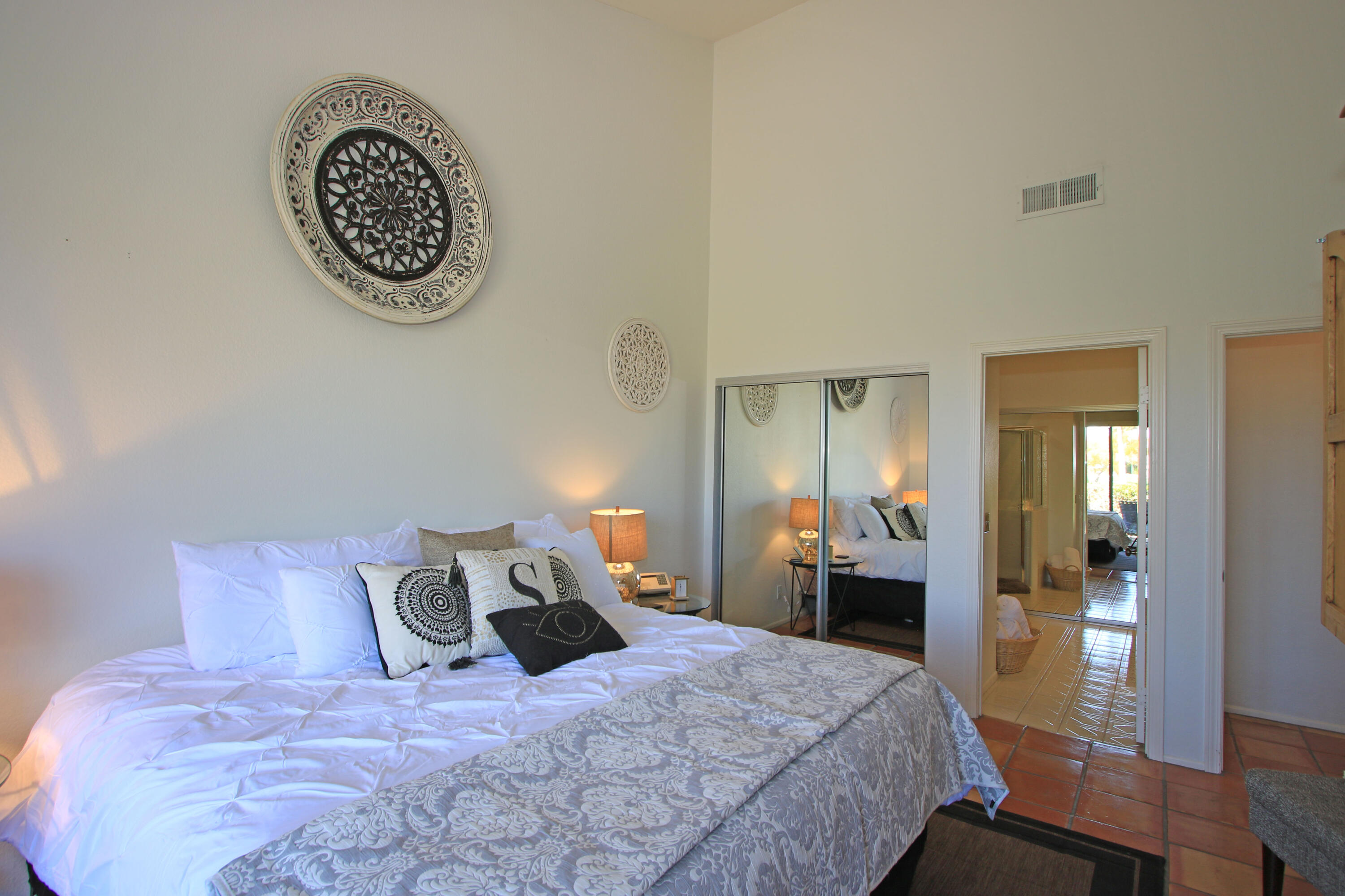 72 Old Ranch Road Palm Desert, CA 92211 - Photo 27 of 35 a bedroom with a bed and a table in it