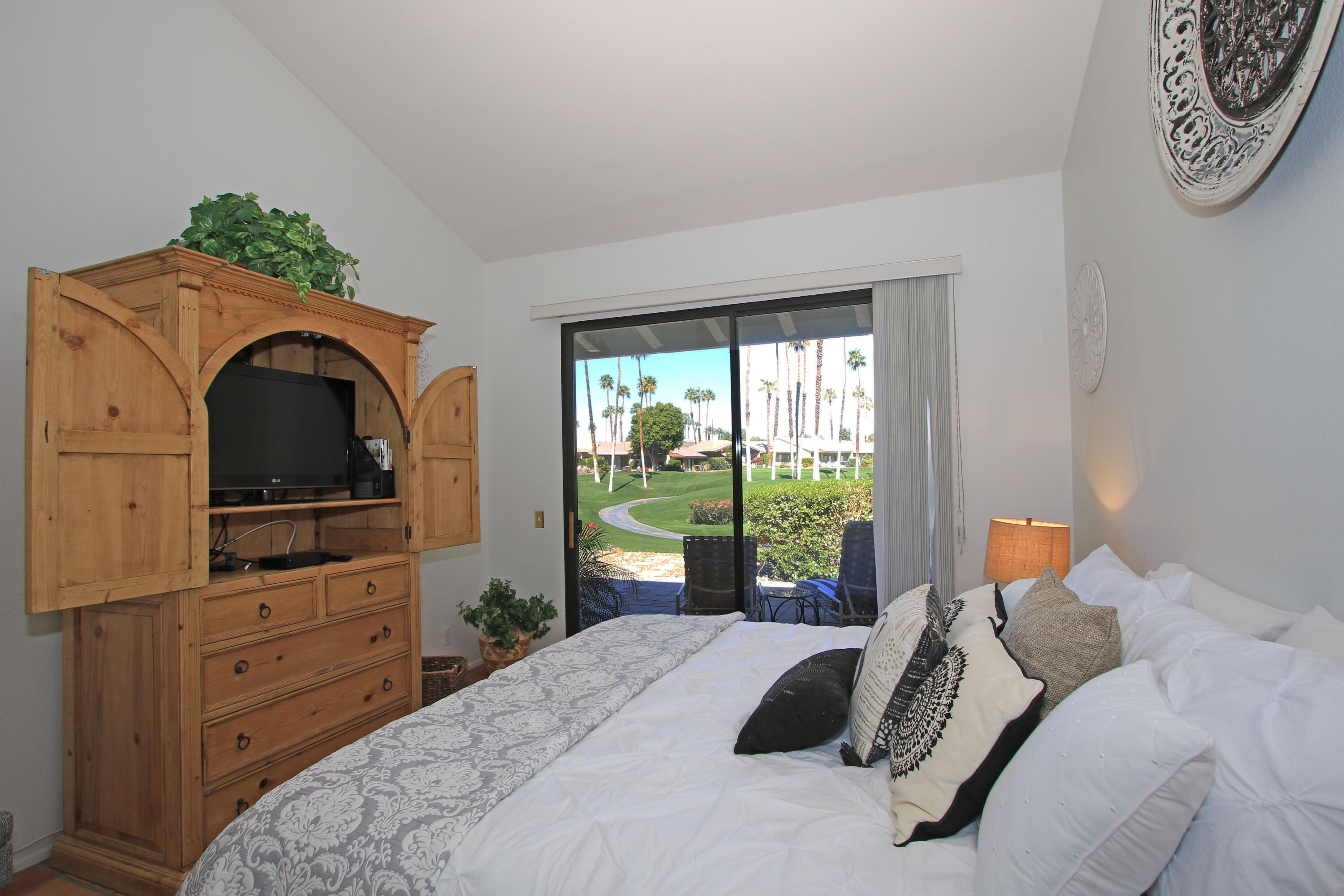 72 Old Ranch Road Palm Desert, CA 92211 - Photo 30 of 35 a bedroom with a bed and a dresser next to a window