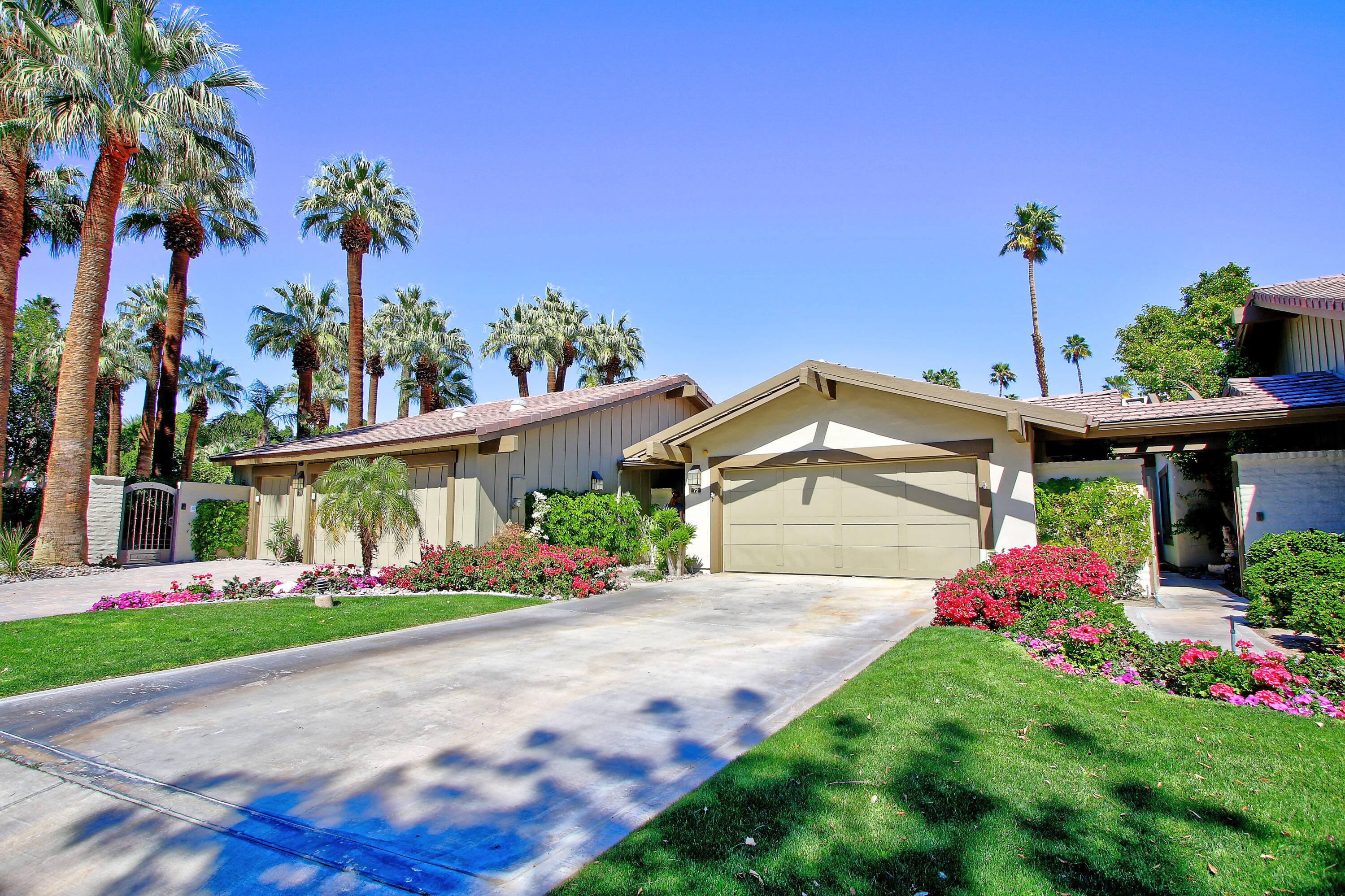 72 Old Ranch Road Palm Desert, CA 92211 - Photo 3 of 35 a front view of a house with a yard and potted plants