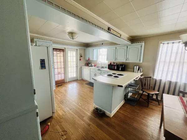 a view of a dining room with furniture and wooden floor
