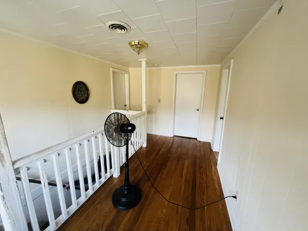 a view of staircase with white walls and a window
