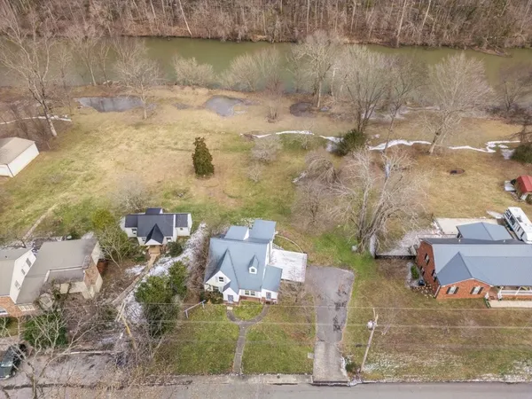an aerial view of a house with a yard