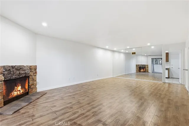 a view of empty room with a fireplace