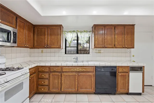 a kitchen with stainless steel appliances granite countertop a sink and cabinets