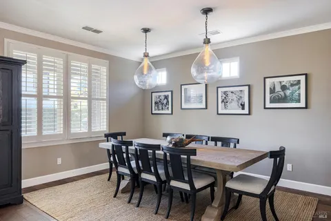 a bedroom with a bed a lamp on desk and a window