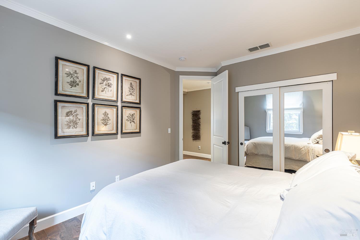 1982 Adams Street Yountville, CA 94599 - Photo 34 of 69 a bedroom with a large bed and a chandelier