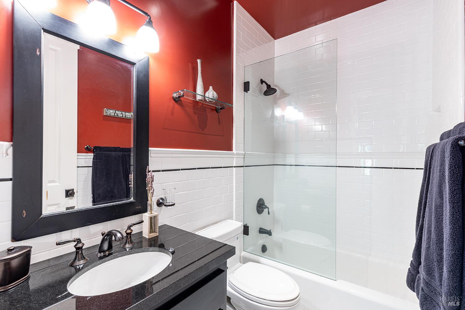 1982 Adams Street Yountville, CA 94599 - Photo 38 of 69 a bathroom with a granite countertop sink toilet a mirror and shower
