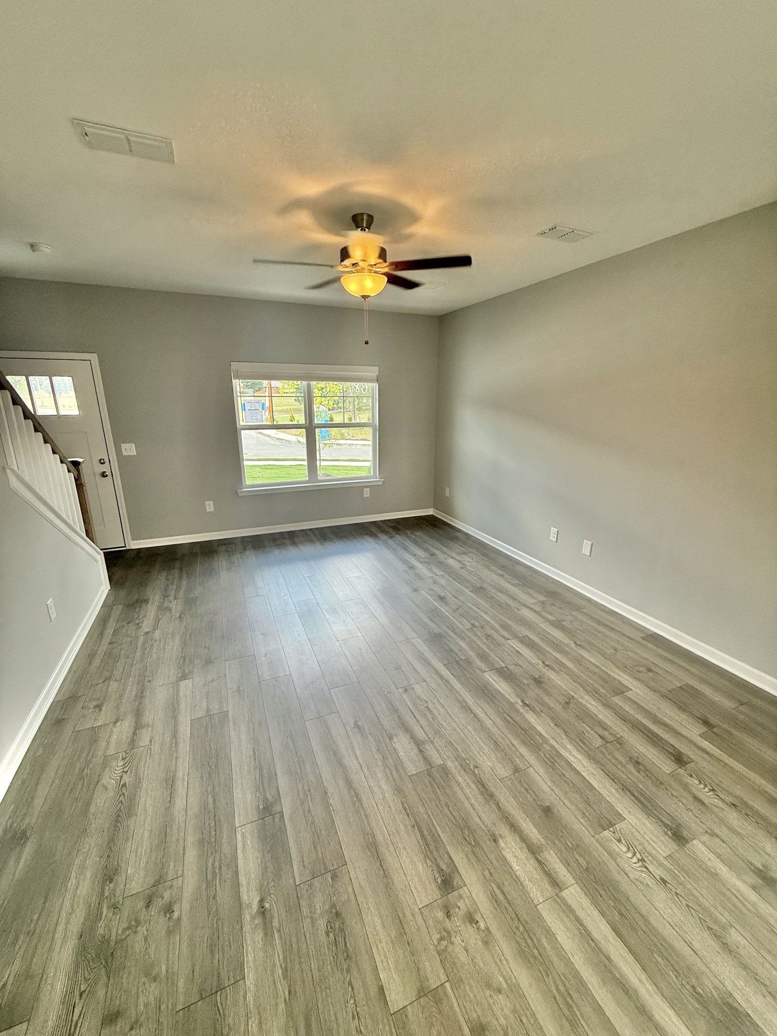 5 Country Circle Manchester, TN 37355 - Photo 2 of 13 wooden floor in an empty room with a window