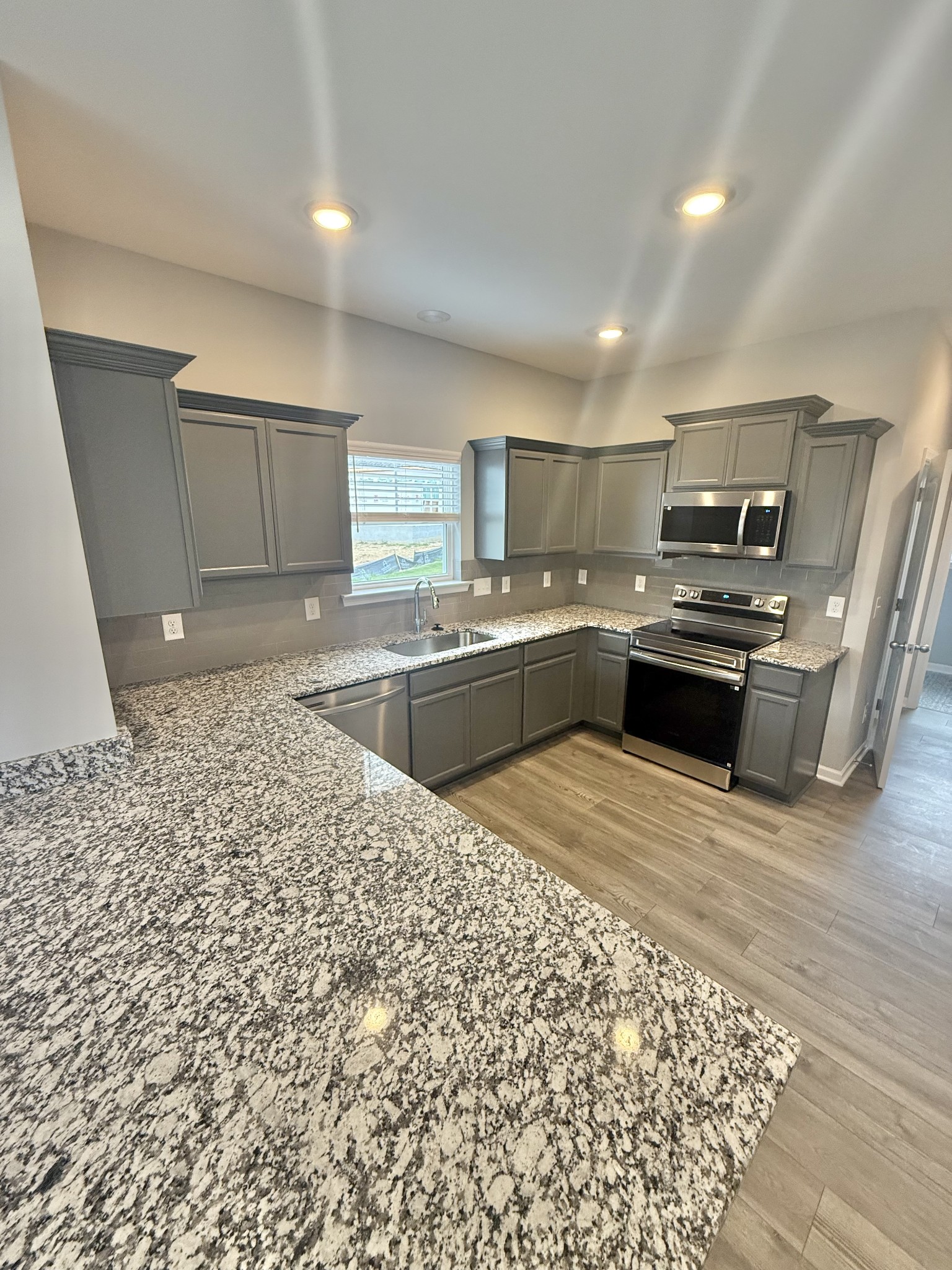5 Country Circle Manchester, TN 37355 - Photo 6 of 13 a kitchen with stainless steel appliances granite countertop a sink stove and refrigerator