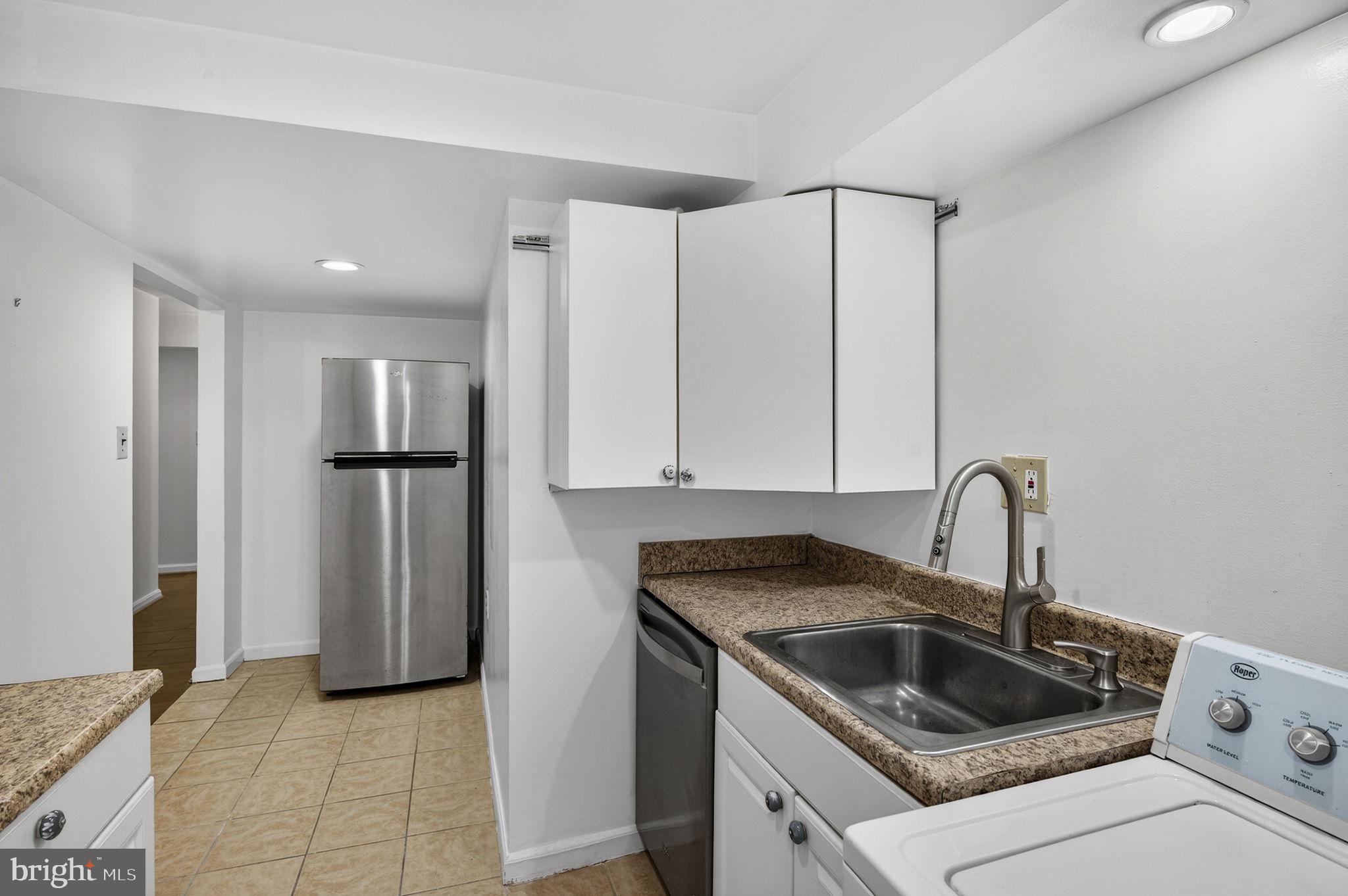 10600 Vantage Court Potomac, MD 20854 - Photo 67 of 91 a kitchen with a refrigerator sink and cabinets