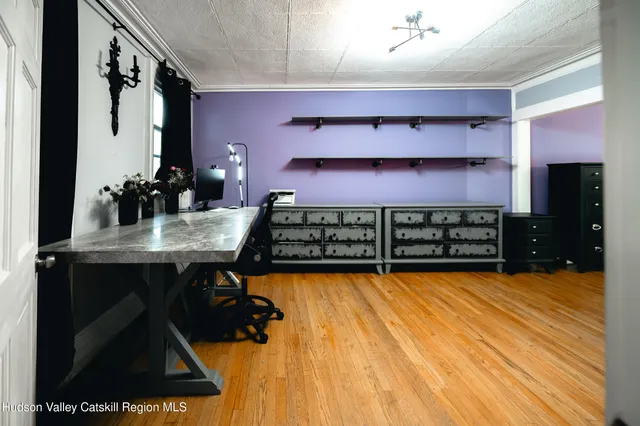 a kitchen with stainless steel appliances wooden floor and wooden cabinets