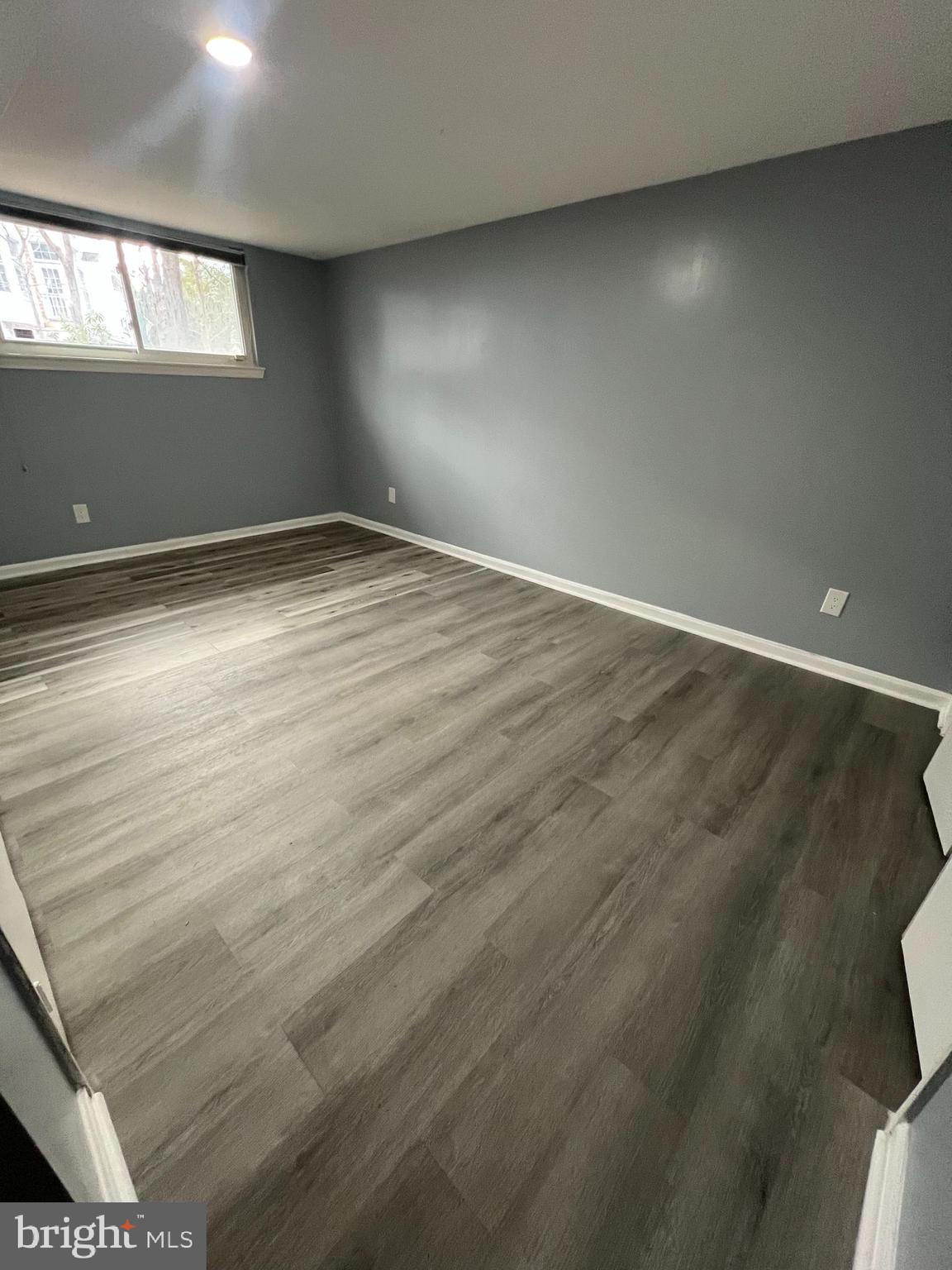 11823 Falls Road Potomac, MD 20854 - Photo 14 of 20 an empty room with wooden floor and windows