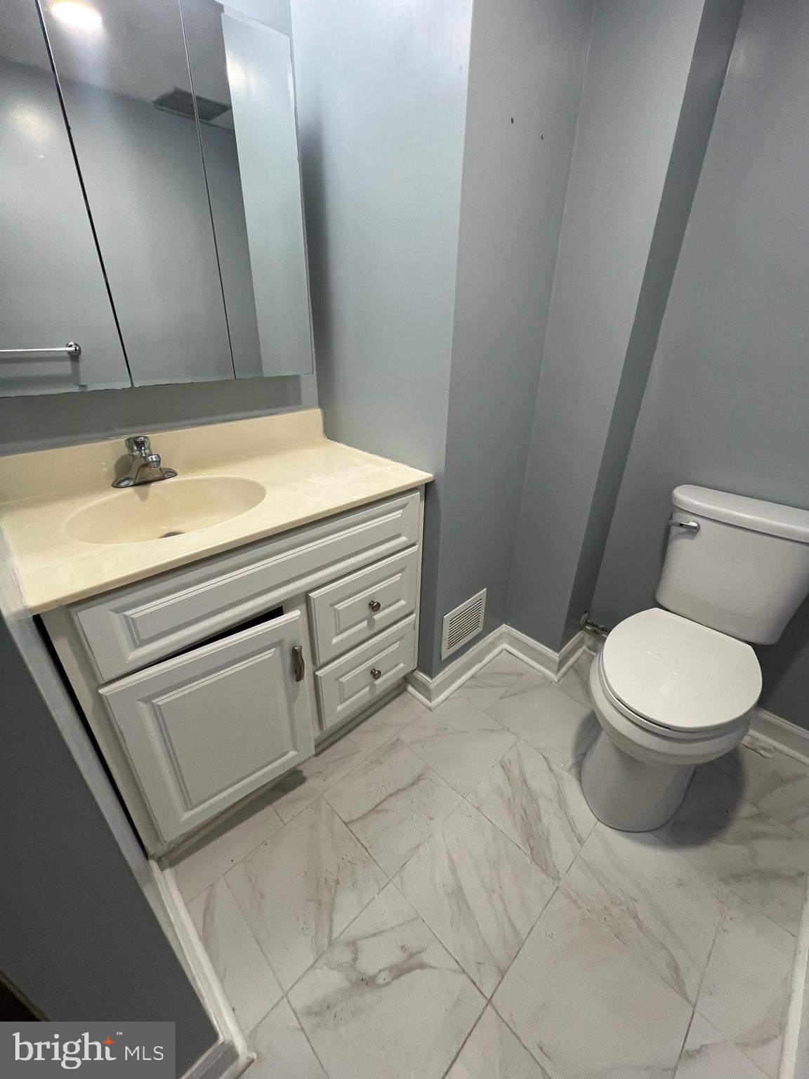 11823 Falls Road Potomac, MD 20854 - Photo 15 of 20 a bathroom with a sink a toilet and mirror