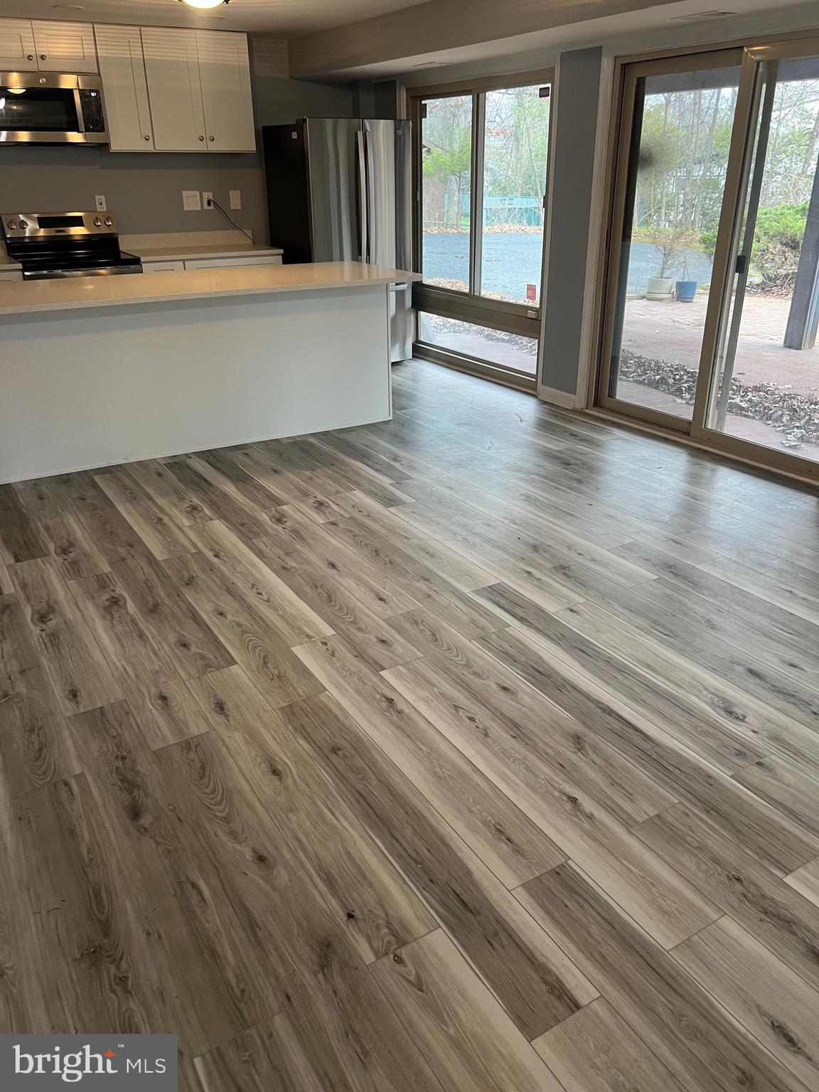 11823 Falls Road Potomac, MD 20854 - Photo 19 of 20 a view of an empty room with wooden floor and a window