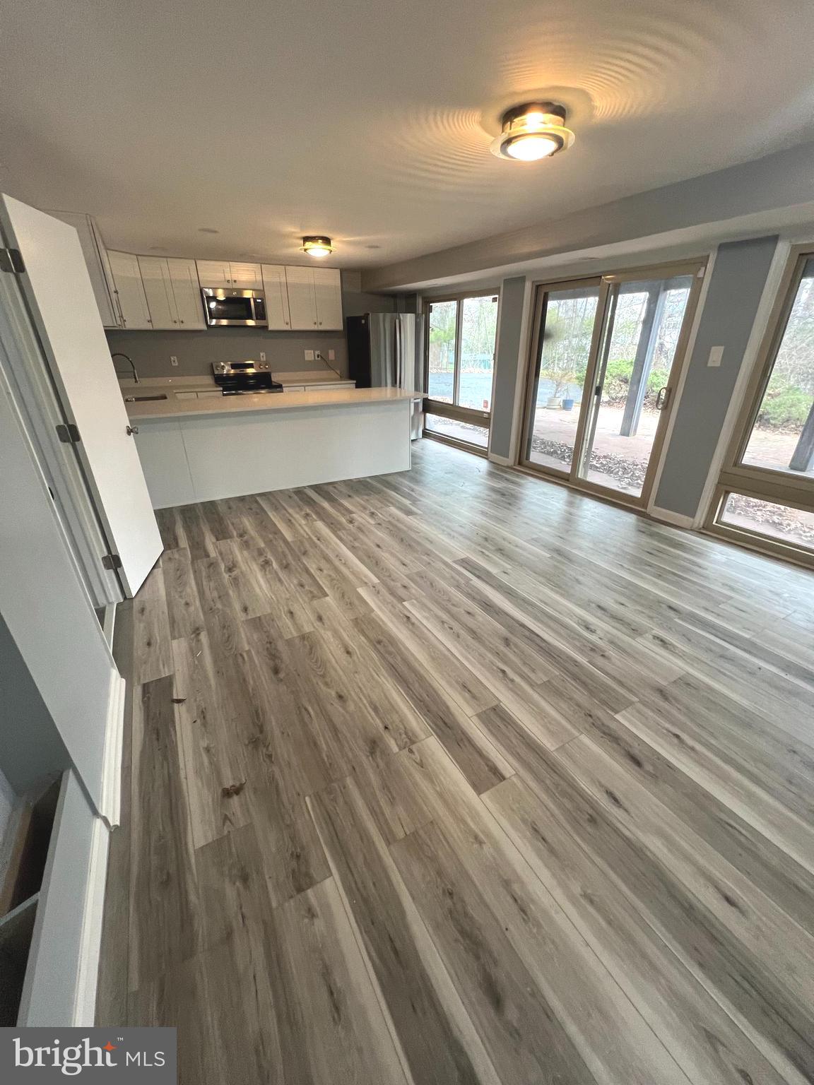 11823 Falls Road Potomac, MD 20854 - Photo 2 of 20 wooden floor in an empty room with a window