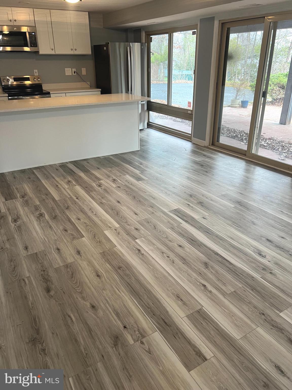 11823 Falls Road Potomac, MD 20854 - Photo 3 of 20 wooden floor in an empty room with a window