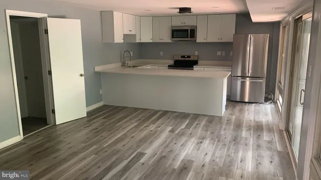 a kitchen with a refrigerator and a sink