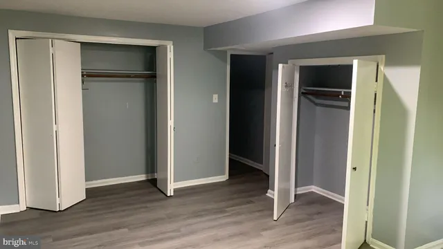 an empty room with wooden floor and closet