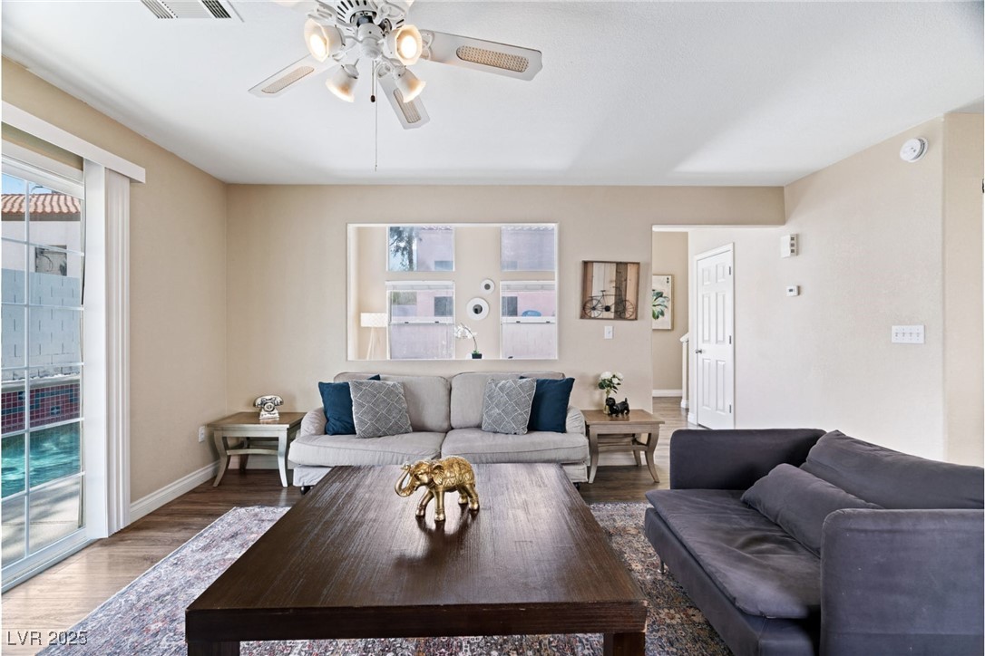 8213 Grassy Point Circle Las Vegas, NV 89145 - Photo 12 of 31 Living room with wood finished floors, baseboards, and a ceiling fan