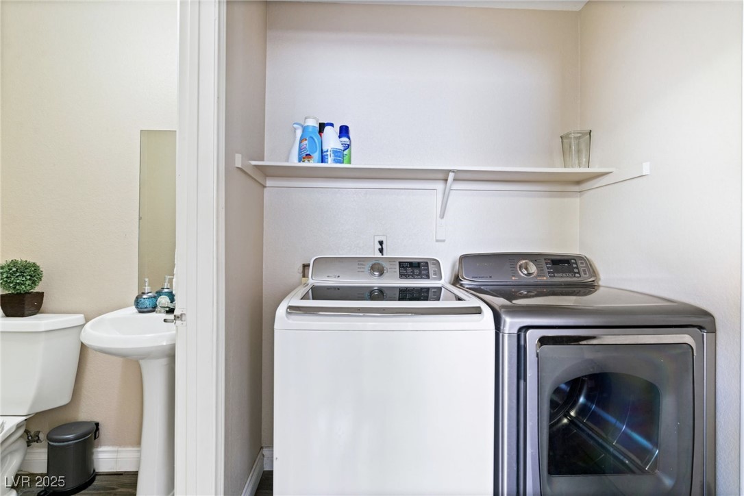 8213 Grassy Point Circle Las Vegas, NV 89145 - Photo 14 of 31 Laundry room featuring independent washer and dryer and a sink