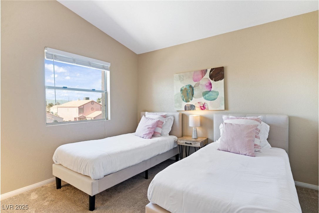 8213 Grassy Point Circle Las Vegas, NV 89145 - Photo 19 of 31 Bedroom with carpet floors, baseboards, and lofted ceiling
