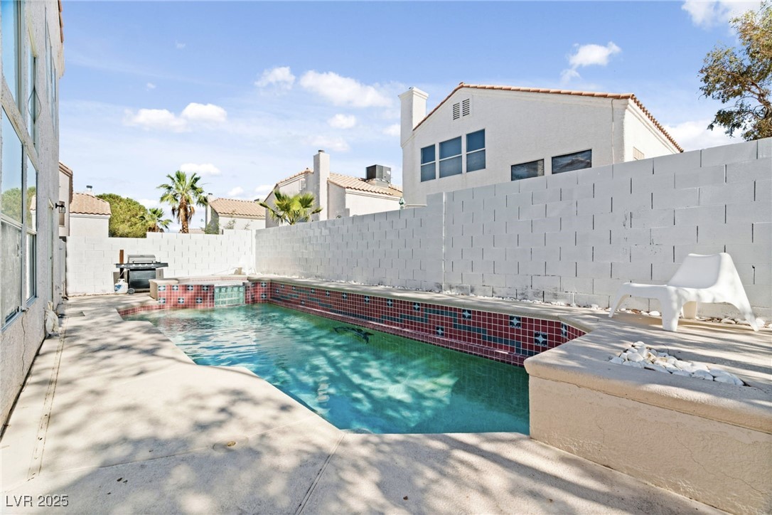8213 Grassy Point Circle Las Vegas, NV 89145 - Photo 27 of 31 View of swimming pool with a patio and a fenced backyard