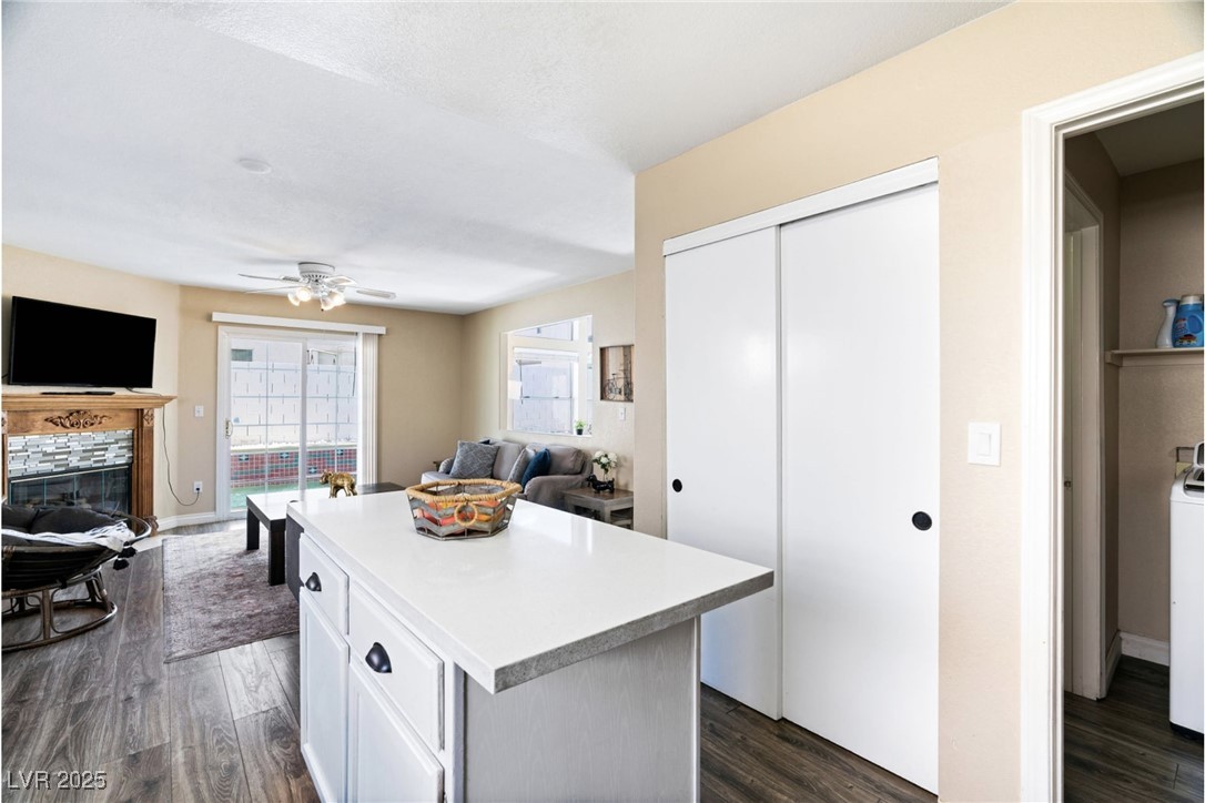 8213 Grassy Point Circle Las Vegas, NV 89145 - Photo 31 of 31 Kitchen with open floor plan, dark wood-style floors, and a kitchen island