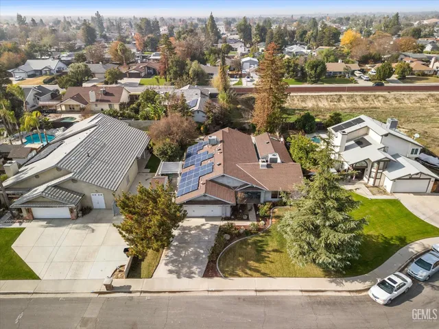an aerial view of a house with a yard