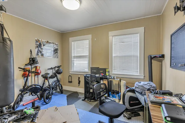 a room with gym equipment and windows