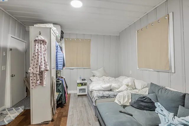 a bedroom with furniture and a window