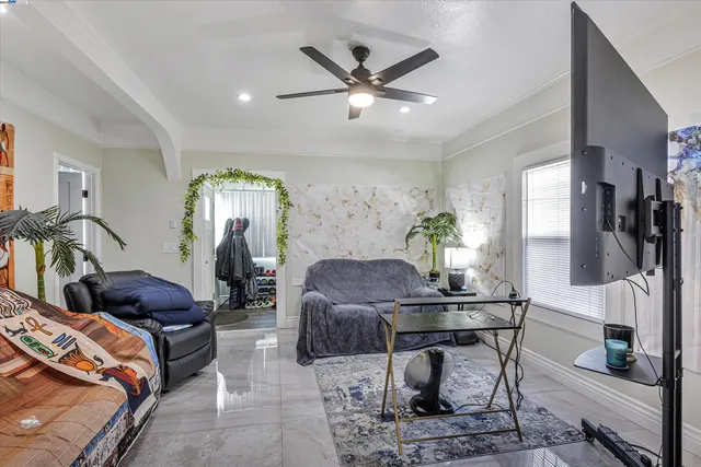 a living room with furniture and a chandelier