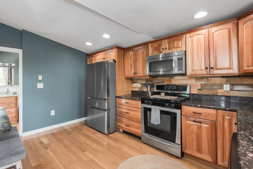 38 Colonial Road Weymouth, MA 02191 - Photo 3 of 38 a kitchen with stainless steel appliances granite countertop a stove a refrigerator and a microwave