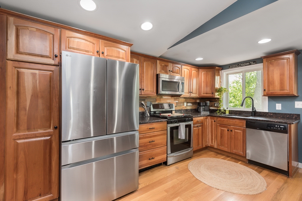 38 Colonial Road Weymouth, MA 02191 - Photo 6 of 38 a kitchen with stainless steel appliances granite countertop a refrigerator stove microwave and sink