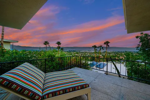 a view of a house with a garden and trees