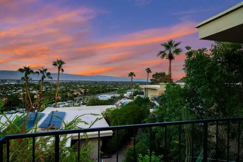 a living room with fireplace furniture and a wooden floor