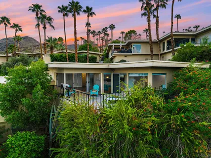 a view of a hallway with wooden floor and a fireplace