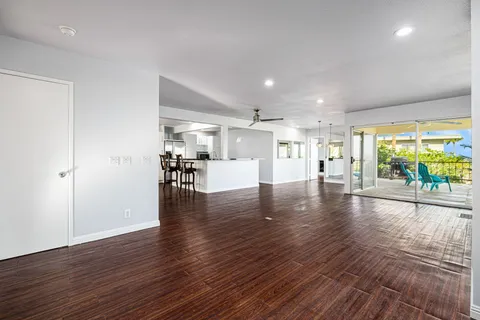 a view of a room with wooden floor and door