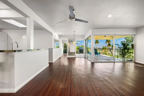 a view of kitchen with cabinets and wooden floor