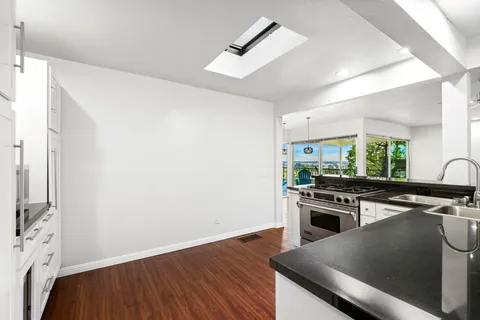a kitchen with white cabinets and stainless steel appliances