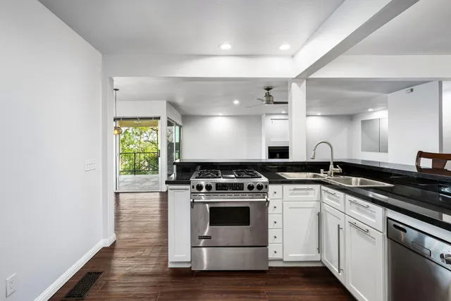 a kitchen with wooden cabinets and stainless steel appliances