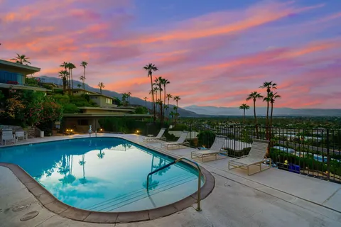 a view of a garden with flowers and trees