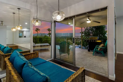 a view of empty room with wooden floor and fireplace