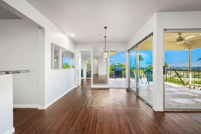a view of a big room with wooden floor and a fireplace