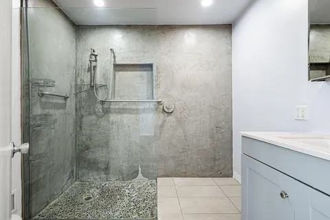 a view of empty room with wooden floor and fireplace