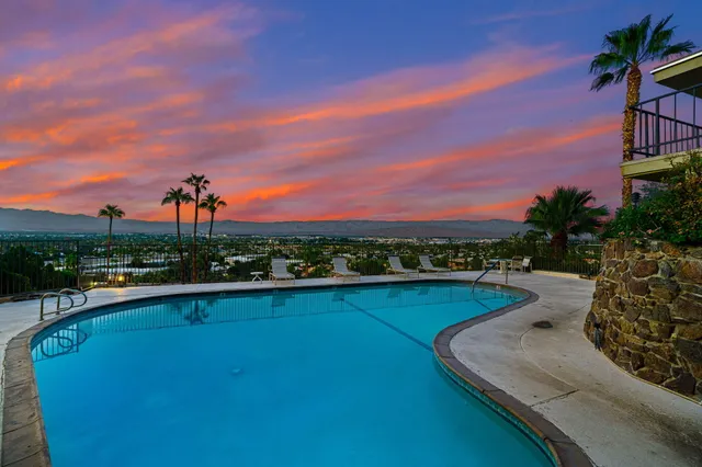 a view of a swimming pool with an outdoor seating